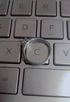 a magnifying glass sitting on top of a computer keyboard