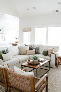 a living room filled with lots of furniture and pillows on top of it's couches