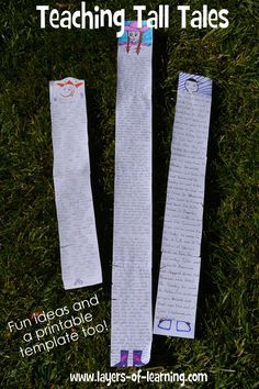 two pieces of paper taped to each other in the grass with writing on them,