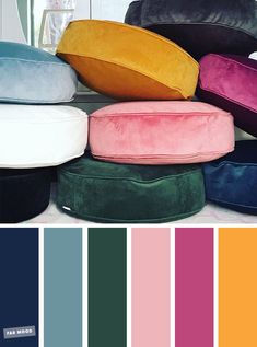 several different colored pillows stacked on top of each other with the same color scheme in front of them