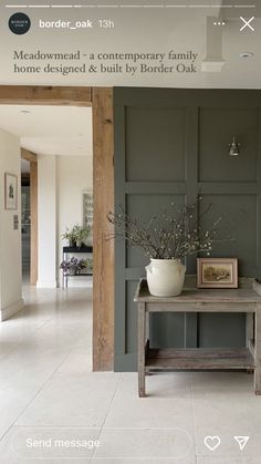 a room with a table and some pictures on the wall next to an open door