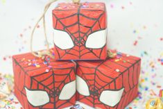 three wrapped presents with spiderman faces on them