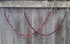 a wooden fence with beads hanging from it