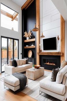 High-ceiling living room with black fireplace wall and wooden beams. Great Room Black Windows, Wall To Ceiling Fireplace, Styling High Ceilings, Slanted High Ceiling Living Room, Vaulted Ceiling Living Room Wall Decor Ideas, Electric Fireplace Ideas High Ceiling, Fireplace With High Ceiling Ideas, Living Room Wooden Beams, 2 Story Fireplace Decor