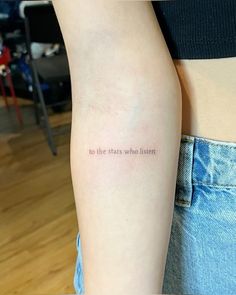 a woman's arm with the words to the stars who listen written on it