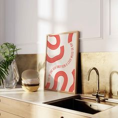 a kitchen counter with a sink, faucet and potted plant