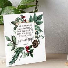 a christmas card with the words grace and forth on it next to a potted plant