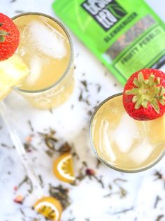 two glasses filled with lemonade and strawberries