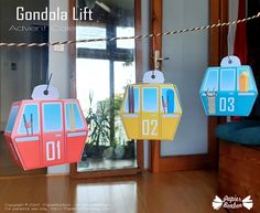 some paper toys are hanging on a line in front of a door that says gondala lift