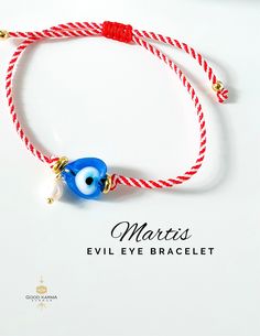 Embrace the tradition and protection of the Martis bracelet with our stunning Adjustable Evil Eye Martis Bracelet. Handcrafted with care, this bracelet features the classic red and white cord, symbolizing the arrival of March in Greek culture, adorned with a beautiful blue heart-shaped glass evil eye bead and a delicate freshwater pearl dangle. The Martis bracelet, also known as the Martaki or March bracelet, is believed to ward off evil spirits and bring good luck and prosperity to the wearer t Hand-strung Heart Jewelry As Gift, Hand-strung Heart Shaped Jewelry For Gift, Hand-strung Heart Shaped Jewelry Gift, Hand-strung Heart Jewelry For Gift, Symbolic Evil Eye Bracelets As Gifts, Handmade Spiritual Heart Bracelet With Adjustable Fit, Handmade Adjustable Spiritual Heart Bracelet, Hand-strung Jewelry As A Valentine's Day Gift, Hand-strung Jewelry For Valentine's Day Gift