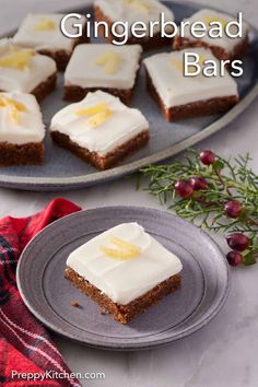 gingerbread bars with white frosting and orange zest are on a gray plate