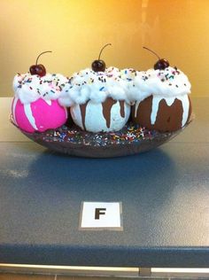 three desserts are sitting on a plate with sprinkles and frosting