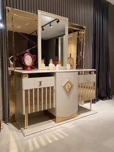 a large mirror sitting on top of a wooden dresser next to a wall mounted clock