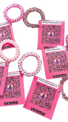 the brochures are all pink and have different designs on them, including one that has a qr code