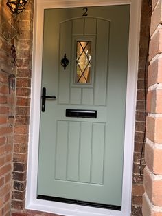 a green front door on a brick house