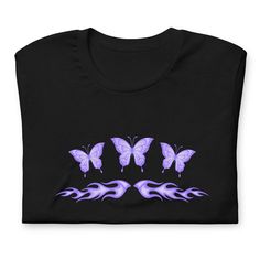 If you're looking for a unique and stylish way to show your love for butterflies, then fairycore's purple butterfly tattoo flames shirt is perfect for you! This shirt features a white butterfly design on the front. Plus, the y2k era grunge style makes it perfect for any alt aesthetic lover out there, while the tribal tattoo gives it an edgy edge that's sure to turn heads. And if you're looking for a cute and fashionable addition to your wardrobe, look no further than this fairycore shirt! 👕 Uni Y2k Purple Graphic Print Top, Aesthetic Summer Streetwear Tops, Rave Style Graphic Print Tops, Rave Graphic Print Tops For Alternative Fashion, Purple Y2k Style Graphic T-shirt, Purple Y2k Graphic Print T-shirt, Purple Y2k Style Graphic Print T-shirt, Y2k Style Purple Graphic Print T-shirt, Tattoo Flames