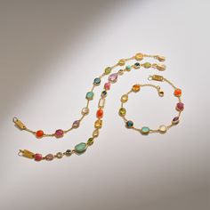 Gems of every hue, in forms that vary from ovals to teardrops, make up the length of this 18K Gold Rock Candy® bracelet. The rich palette of gems owes its colors to dark amethyst, green-gold citrine, rock crystal, mother-of-pearl, lapis, peridot and Swiss blue topaz. Vibrant and mood-boosting, the piece can elevate any look, from party dresses to simple tanks and tees. • 18K Gold • Gemstones: Dark Amethyst, Green Gold Citrine, Rock Crystal, Mother-of-Pearl, Lapis, Peridot, Swiss Blue Topaz Dark Amethyst, Candy Bracelet, Hinged Ring, Gold Chain Bracelet, 18k Gold Chain, Gold Confetti, Teardrop Necklace, Gold Bracelet Chain, Swiss Blue Topaz