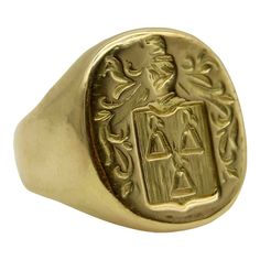 This 18k gold Tiffany & Co. Larter & Sons signet ring is hand carved with a heraldic family crest. The crest has a shield with three bell-like shapes sprouting flowers. Above the shield is a knight’s helmet topped with a feather and surrounded by scrolling foliate. The classic design of the crest suggests royalty and valor.  Larter & Sons was founded in 1865 and was renowned for their exquisite craftsmanship of men’s accessories. They expanded to include women’s jewelry in the early 20th century, using intricate techniques such as guilloche and enamelwork, and incorporating motifs inspired by nature. They collaborated with Tiffany & Co. to make jewelry such as cufflinks and signet rings. Tiffany & Co. would often consign well-known brands of the highest quality, including Larter & Sons. Classic Signet Ring For Commemoration, Classic Polished Signet Ring For Commemoration, Classic Engraved Signet Ring For Commemoration, Classic Ceremonial Signet Ring With Polished Finish, Luxury Engraved Signet Ring For Commemoration, Luxury Engraved Ring With Polished Finish For Commemoration, Luxury Engraved Ring For Commemoration With Polished Finish, Classic Collectible Signet Ring With Engraving, Classic Engraved Ceremonial Signet Ring