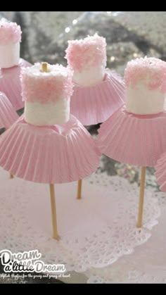 pink and white cupcakes with frosting on them