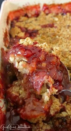 a close up of food in a pan with a spoon