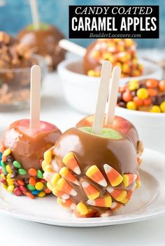 candy coated caramel apples on a white plate