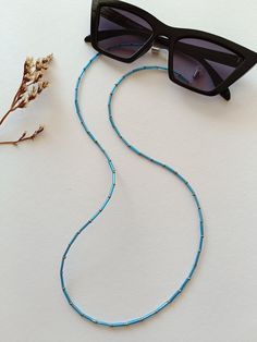 An elegant Eyeglass chain for your sunglasses or reading glasses. Approximately size of the chain is 65cm. It comes with a glasses connector that is removable. Blue Glasses Chains With Colorful Beads For Beach, Blue Beaded Glasses Chain For Beach, Blue Glasses Chain With Colorful Beads As Gift, Blue Glasses Chain With Colorful Beads For Gift, Blue Glasses Chains With Colorful Beads As Gift, Blue Glasses Chains With Colorful Beads For Gift, Blue Beaded Long Necklace With Adjustable Chain, Blue Long Beaded Necklace With Adjustable Chain, Adjustable Blue Glasses Chains With Colorful Beads