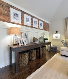 a living room filled with furniture and pictures on the wall above it's coffee table