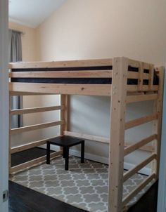 a wooden bunk bed sitting in a bedroom next to a window