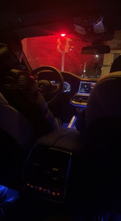 the interior of a car with its lights on and it's dashboard lit up