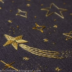 some gold stars are on a blue cloth