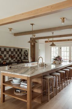 a large kitchen island with lots of counter space and stools in front of it