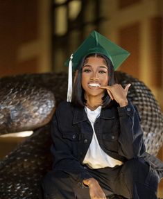 a woman in a graduation cap sitting on a chair