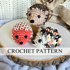 three crocheted hedges sitting on top of a wooden slice