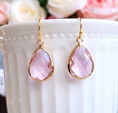 Gorgeous earrings feature faceted pink glass in pear shape encased in silver frame.  On gold plated brass earwires.   FEATURES: * tear drop crystal glass * classic style * gold plated brass earwires MEASUREMENTS: Earring length: 30 mm Drop length: 20 mm Teardrop size: 13*18 mm Free Gift Wrapping on request - All items that are gift wrapped come in with a kraft box with raffia string and blank writing card.  Please leave a note if you need it upon ordering. Pink Teardrop Crystal Earrings, Gold Teardrop Earrings For Bridesmaid Gift, Pink Drop Earrings, Pink Crystal Earrings, Crystals Earrings, Earrings Pink, Crystal Drop Earrings, Large Earrings, Pink Glass