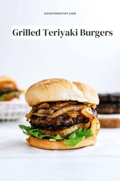 grilled teriyaki burgers with onions and lettuce on the side