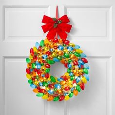 a christmas wreath hanging on a door with candy candies in the shape of a ring