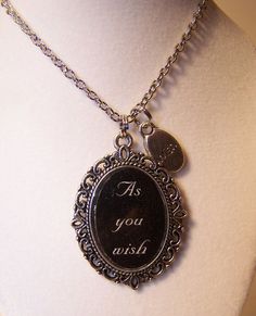 a necklace with a quote on it that says as you wish hanging from a mannequin