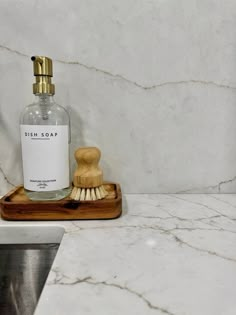 a soap dispenser sitting on top of a marble counter