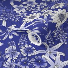 a blue and white flowered background with large flowers on the left side of the image