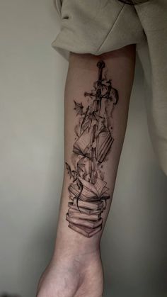 a person's arm with a tattoo on it that has an image of a ship in