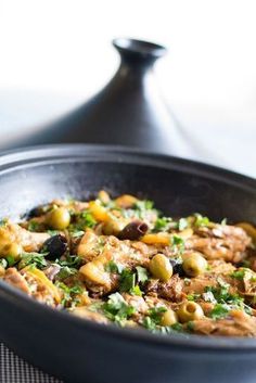 a skillet filled with food sitting on top of a table