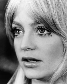 a black and white photo of a woman with long eyelashes