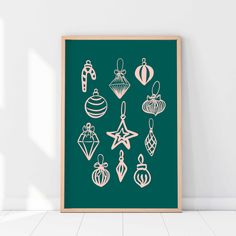 a green poster with christmas ornaments on it in front of a white wall and floor