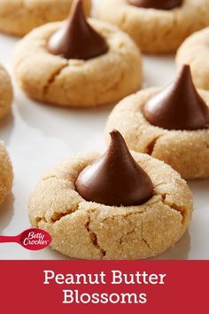 cookies with chocolate frosting on top and the words classic peanut butter blossom cookies below