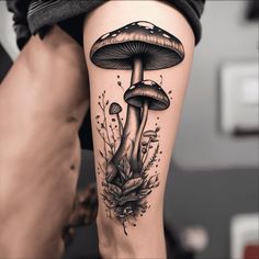 a woman's leg with a mushroom and flowers tattoo design on the calf area