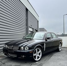 a black car parked in front of a building