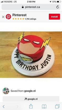 a birthday cake with the words happy birthday just in front of it and an image of a flash man on top