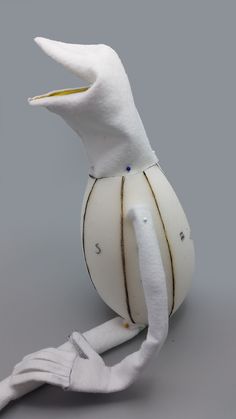 a white stuffed bird sitting on top of a table