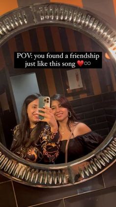 two women taking a selfie in a mirror with the caption pov you found a friend just like this song