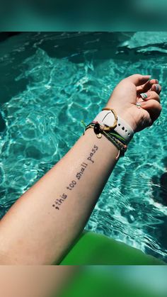 a person with a wrist tattoo that says, i love you more than the water